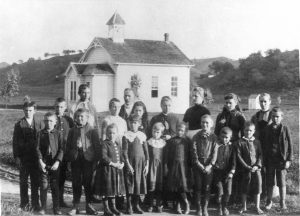 Eagle Rock’s First School in 1889. It was built by community volunteers in 1886 near Colorado Boulevard just east of Caspar Avenue. The teacher, shown at rear, was Will Frackleton. The donor of this photo was fifth from the left in front. Previously, Lida Hutchins taught seventeen pupils in 1884 in a barn on Addison Way owned by Milton Brown. The next year Miss Augusta Stevens moved the class to her own house. (Courtesy the Elena Frackelton Murdock family)