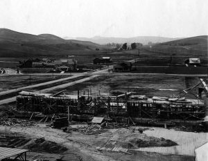 The Skeleton of Swan Hall Dormitory Alumni Avenue stretches to York Boulevard and Campus Road wraps around. We are standing on the hill where Orr Hall dormitory will be built and looking down the valley, which will become Glassell Park, to the Los Angeles River in the distance. Unseen to our right are Johnson and Fowler Halls, The area in the center, just over Ralph Rogers house, is the location of an artesian spring, now tapped by Sparkletts Water Company (Courtesy of College Archives—Occidental College Library)