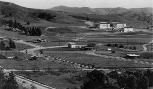Occidental College from the Hills Northwest The first three buildings are completed but unoccupied in 1914. Eagle Rock Boulevard is the divided street running left to right in the center of the photo. The street layout is as it is today. Johnson and Fowler Halls, the paired buildings, were classrooms and administration. Swan Hall in front was the first dormitory. This was unincorporated land located south of the City of Eagle Rock. (Contributed by Louise White Puthuff, postcard photograph by B.D. Jackson)