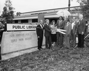 The Ribbon Cutting By1980 a new library was needed. A new more acessable facility was constructed on Merton Avenue. Here Senator Edward Roybal, Councilman Arthur K. Snyder, Mayor Tom Bradley, TV weatherman George Fischbeck and other dignitaries cut the ribbon on October 3, 1981. The facility boasted 12/500 square feet of space and could hold up to 72,800 volumes.  