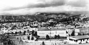 Toland Way Elementary, Circa 1938. In a similar view, the original masonry building, opened in 1925, stands in front of the western York Valley. Occidental College is on the upper right. Trees now conceal Eagle Rock Boulevard on the left. Below, the students construct an outdoor theater behind the school, one of many in the area.  (Courtesy LAUSD Art and Artifact Collection.)