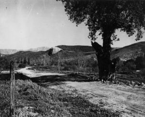 The earliest known photograph of the valley of the rock Circa 1895. The dirt road is now Figueroa Street. In the distance is the Stewart ranch house and a row of tents, perhaps health seekers hear for the beneficial climate. (Los Angeles County Museum)