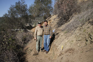 John Stillion, right, heard by chance that the four acres north of the rock were for sale. The Collaborative Eagle Rock Beautiful, using funds raised by the community to “Save the Rock”, was able to make a down payment toward the purchase of the land. Master trail builder Peter Schaller, left, volunteered to supervise construction of a trail to the top of the plot. The nearly one mile loop trail was completed in 2008 and is now open to the public. (Photograph by Harry Chamberlain)