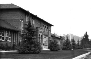 The main classroom building facing Fair Park Avenue was added around 1927, it became the main entrance and remains so today. The sign over this entrance still says Eagle Rock School. All of the schools were now part of the Los Angeles School District and had non-directional names. The PTA planted the deodars during the presidency of Valley Knudsen, a beautification activist; she went on to found Los Angeles Beautiful. She and her husband owned Knudsen’s Dairies. -LAUSD Art and Artifact Collection.