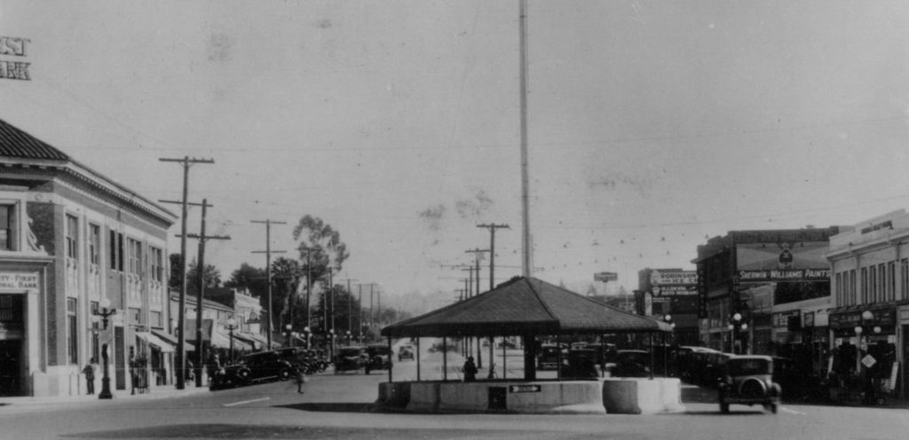 The business center at Eagle Rock and Colorado Boulevards had continued to grow in 1927 with the construction of the three story Ritchy Hardware building on Caspar, and the post World War I addition of a trolley waiting area and flag pole in the center of the intersection, dubbed the "Merrie Go Round”. The concrete structure became a great obstacle to increased auto traffic and was removed in the mid-thirties perhaps embodying a shift of priorities from rail to automotive transit. (ERVHS)