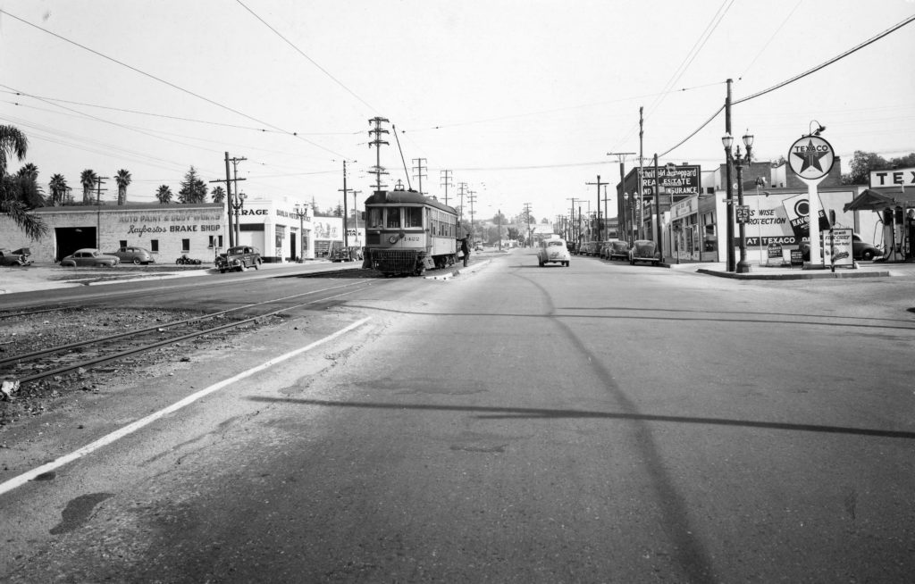 The streetscape looking east from Mt. Royal Drive is shown in 1946. The Dahlia Motors building is to the left. A gas station is on the corner to the right. (Southern California Railway Museum, Ray Younghans photograph)