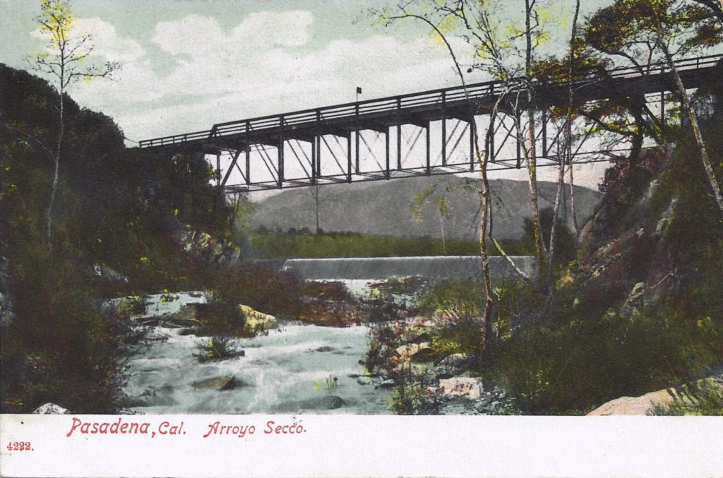 The Scoville Bridge across the Arroyo Seco Stream was the first built to carry cars across the water. It was a reused section of a railway trestle. The dam impounded water to irrigate the orange orchards in the arroyo. (ERVHS)