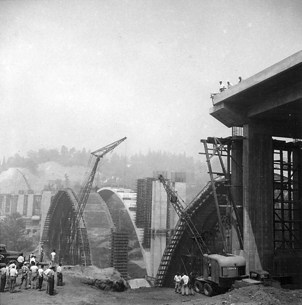 The first component of the new freeway across the Arroyo Seco is shown under construction. This gives a feeling for the scale of the roadway. (Photo by Herald Ohannesian-ERVHS Ohannesian Family Collection)